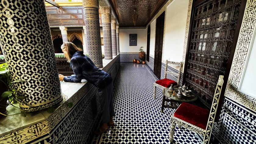 Fez Morocco Tours Riad Interior with Woman Peering Over Balcony