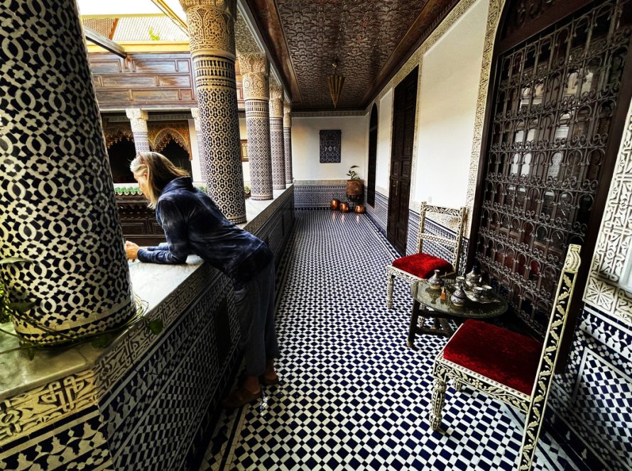 Fez Morocco Tours Riad Interior with Woman Peering Over Balcony