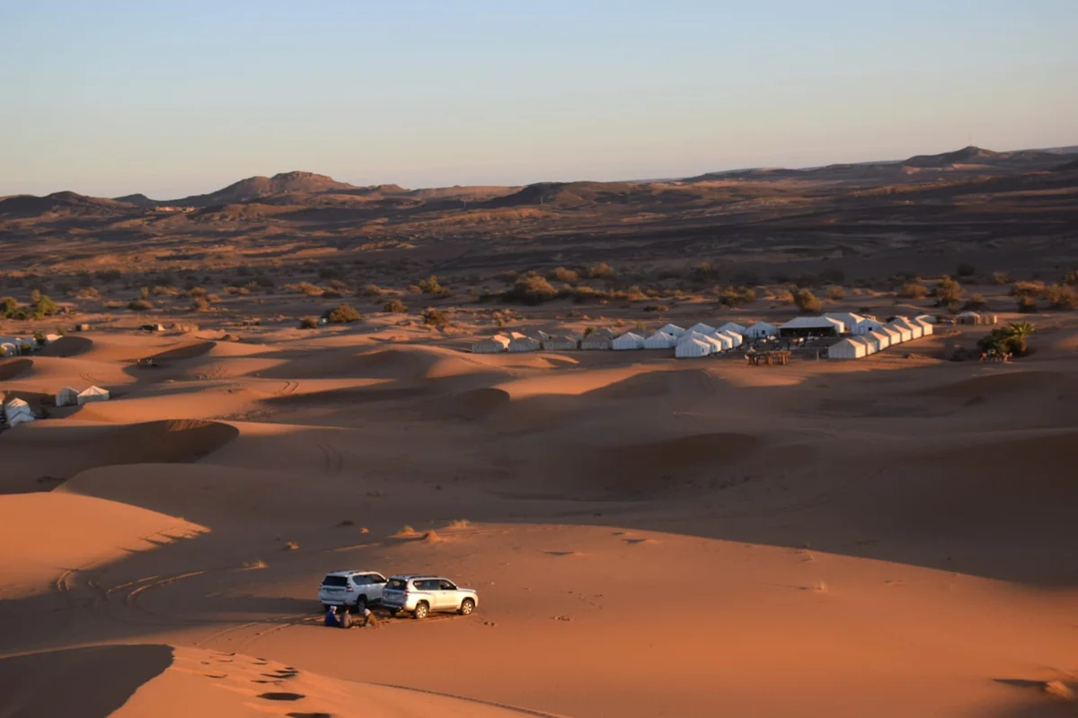 4x4 vehicle driving across the Erg Chebbi dunes in Merzouga, Morocco
